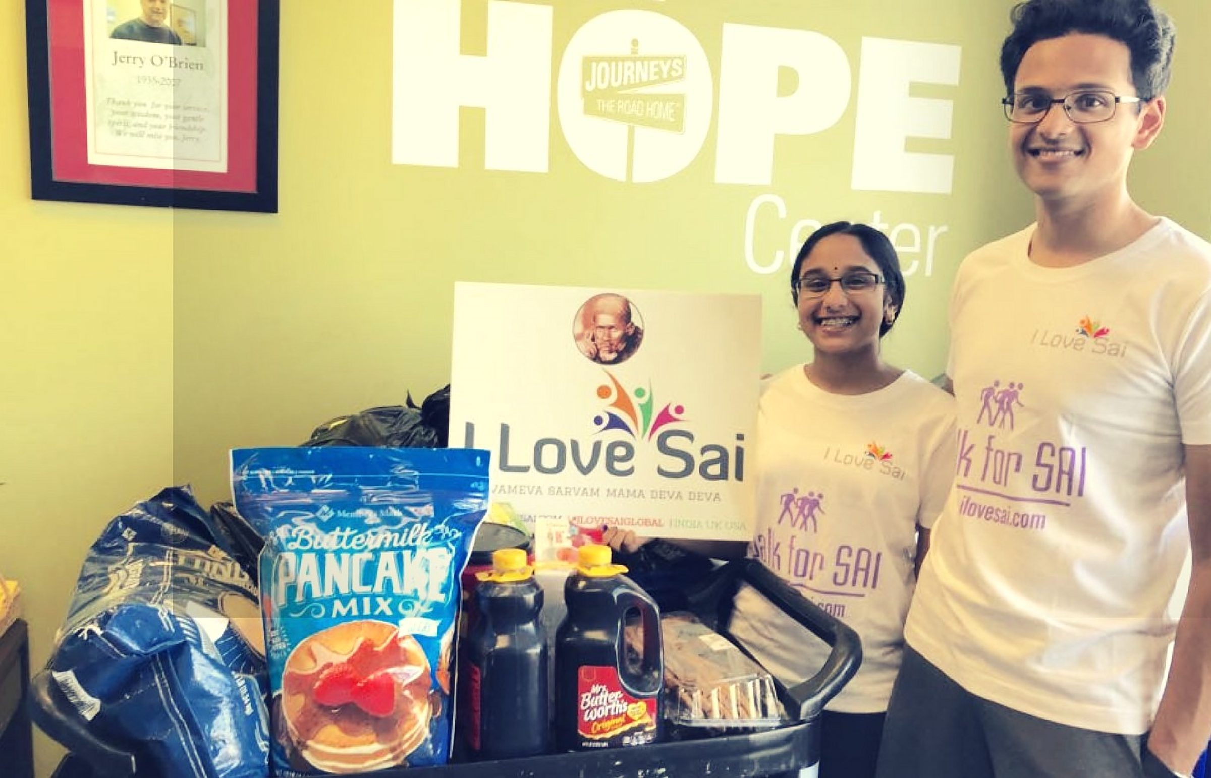 I Love Sai volunteers with donated groceries at the Journeys | The Road Home HOPE Center
