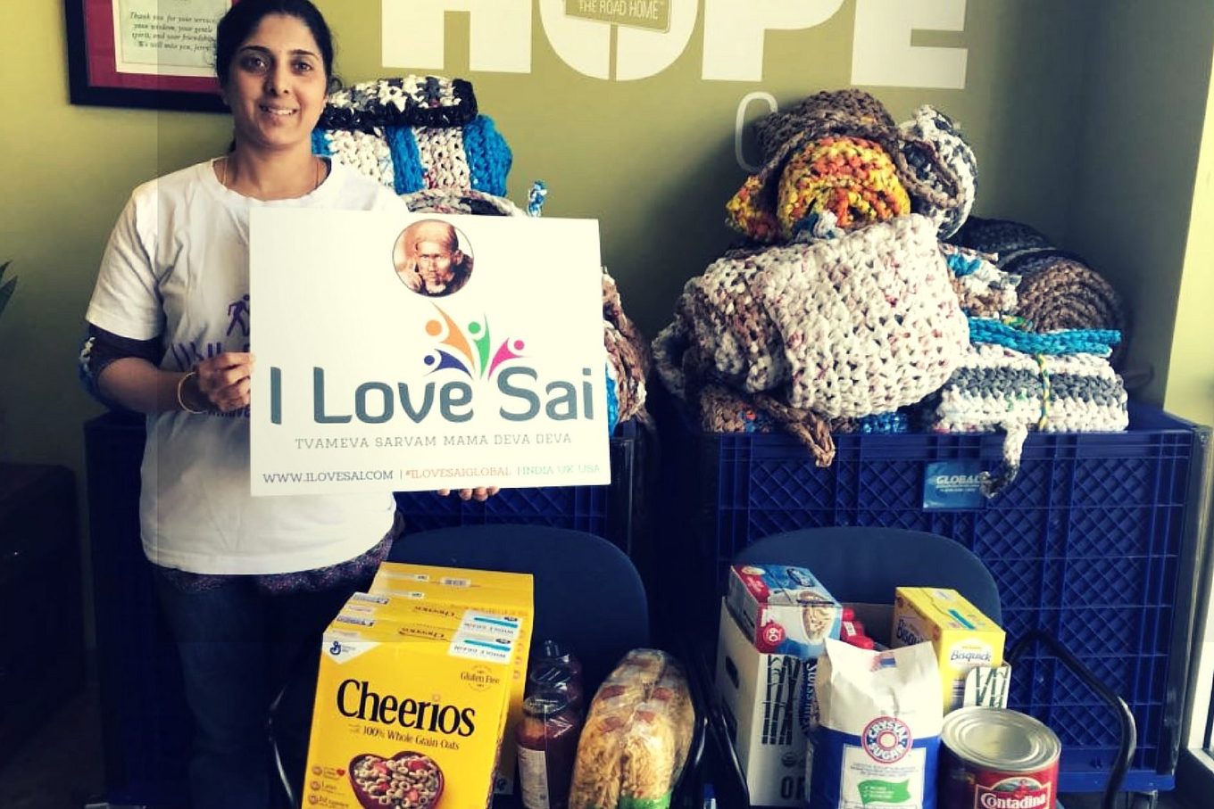 A volunteer with donated blankets and food at the HOPE Center